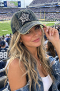 A distressed denim baseball cap featuring a large silver rhinestone star patch on the front. The cap has a faded blue wash, white contrast stitching, and a curved brim.