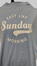 A heather blue short-sleeve t-shirt, featuring a cream-colored graphic text that reads 'EASY LIKE Sunday MORNING'.