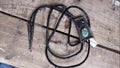 A vintage-style black braided bolo necklace with a square black pendant featuring a turquoise stone inlay.